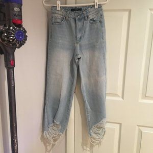 light blue denim jeans ripped at the bottom